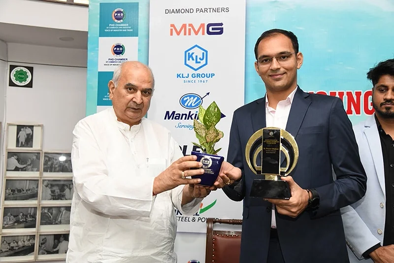 Karma ayurveda's founder: Dr Puneet Dhawan receiving award's from 